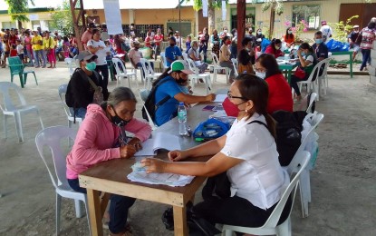 <p><strong>TYPHOON AID.</strong> A resident of Cauayan, Negros Occidental receives a cash aid of PHP5,000 granted by the National Housing Authority to families affected by Typhoon Odette, during the payout held on June 14, 2022. The NHA released PHP90 million fund to Negros Occidental to help rebuild the damaged houses of thousands of affected residents. <em>(Photo courtesy of PIO Negros Occidental)</em></p>