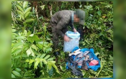 <p><strong>RECOVERED</strong>. The former rebel turned militiaman checks some of the anti-personnel mines and war tools unearthed on Monday (June 13, 2022) in upland Pinanag-an village in Borongan City, Eastern Samar. The soldiers managed to locate the hiding place through information from the former rebel. <em>(Photo courtesy of Philippine Army)</em></p>