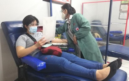 <p><strong>BLOOD DONATION</strong>. Jamie Malingan, 26, donates blood in Baguio City in this undated photo. She said she donates every three months not only to help others but also to stay healthy. <em>(PNA photo by Liza T. Agoot)</em></p>