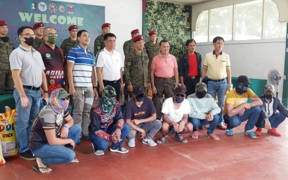 <p><strong>RIGHT DECISION.</strong> Seven members of the extremist Bangsamoro Islamic Freedom Fighters (BIFF), all seated in front, pose with local and military officials following their surrender in Sultan Kudarat, Maguindanao Monday (June 13, 2022). At least 132 BIFF rebels have yielded in Central Mindanao since January this year.<em> (Photo courtesy of 1BCT)</em></p>