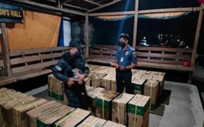 <p><strong>SMUGGLED CIGARETTES.</strong> Policemen inspect the boxes of smuggled cigarettes seized Friday (June 17, 2022) in Barangay Ayala, Zamboanga City. The cigarettes are among the P4.6 million worth of smuggled cigarettes that were confiscated by policemen over the past two days in the city.<em> (Photo courtesy of Area Police COMMAND-Western Mindanao)</em></p>