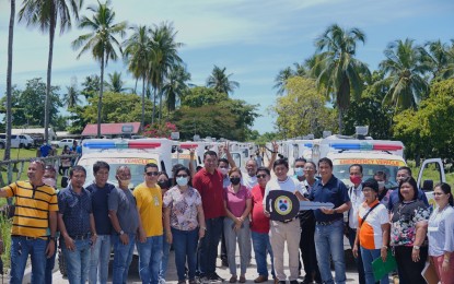 <p><strong>RESCUE VEHICLES.</strong> Davao Oriental Gov. Nelson Dayanghirang (holding the key in a white shirt) is joined by the representatives of various barangays during the turnover ceremony Wednesday (June 15, 2022) of the 50 emergency rescue vehicles. The vehicles will be used to address the need for disaster response in geographically isolated and disadvantaged areas.<em> (Photo courtesy of Davao Oriental PIO)</em></p>