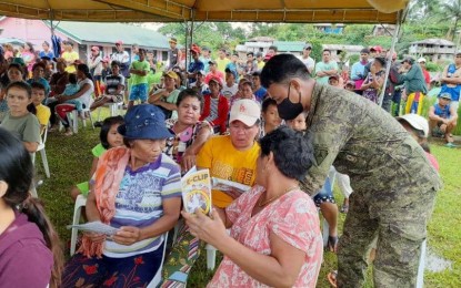 <p><strong>DIALOGUE</strong>. A soldier explains to villagers in a remote, hinterland barangay in Sta. Catalina, Negros Oriental, the benefits of E-CLIP for members of the New People's Army who will surrender. The 11th Infantry Battalion of the Philippine Army held a forum, followed by a peace concert, on Sunday (June 19, 2022) in Sitio Kanggabok in Barangay Nagbinlod.<em> (Photo courtesy of the 11IB, PA)</em></p>