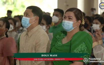 <p><strong>BLESSING.</strong> Vice President-elect Sara Duterte (right) and husband, Mans Carpio, attend the Mass at San Pedro Cathedral preceding her inauguration held just outside the church on Sunday (June 19, 2022). In her speech, Duterte highlighted the importance of families in raising children who will contribute to society and the nation.<em> (Screenshot)</em></p>