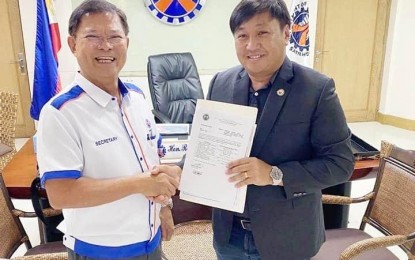 <p><strong>ROAD CONVERSION.</strong> Department of Public Works and Highways Secretary Roger Mercado hands in to Apayao Cong. Elias C. Bulut Jr. on Tuesday (June 21) the DPWH order declaring the conversion of seven local roads into national highways. The conversion is expected to spur economic development and opportunities in rural communities in northern Luzon. <em>(Contributed)</em></p>