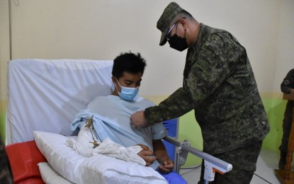 <p><strong>HONORED.</strong> Maj. Gen. Robert Capulong, the Army’s acting 6th Infantry Division commander, pins a medal on 1Lt. Jomar C. Binay-an in a ceremony held inside the Camp Siongco Hospital in Maguindanao Tuesday (June 21, 2022). The young officer was wounded in a clash between his unit and communist rebels in Sultan Kudarat’s town of Palimbang. <em>(Photo courtesy of 6ID)</em></p>