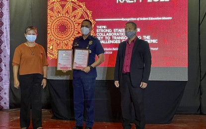 <p><strong>MORE SCHOOLS</strong>. Department of Education (DepEd) Laoag City officials, led by schools division superintendent Vilma Eda (left) and assistant schools division superintendent Arnel Bandiola (right), award a certificate of appreciation to the Philippine National Police on Thursday (June 23, 2022) for their support in the pursuit of quality learning in the "new normal." DepEd Laoag also assured learners to get better access to schools near them. <em>(Photo by Leilanie G. Adriano)</em></p>