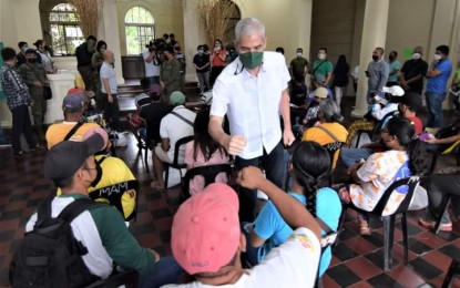 <p><strong>FORMER REBELS.</strong> Negros Occidental Governor Eugenio Jose Lacson greets former communist rebels during the turnover of government financial assistance to former Communist Party of the Philippines-New People’s Army rebels at the Provincial Capitol in Bacolod City on June 22, 2022. During his inauguration address on Saturday (June 25, 2022), Lacson said the provincial government is eager to welcome back those who are still active in the rebel movement.<em> (Photo courtesy of PIO Negros Occidental)</em></p>