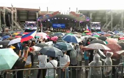 <p><strong>#SALAMATPRRD</strong>. Thousands of supporters and fans brave rains to witness the "Salamat PRRD" thanksgiving concert at the Quirino Grandstand in Manila on Sunday (June 26, 2022). President Rodrigo Roa Duterte along with the outgoing and incoming government officials attended the event. <em>(Screengrab from video of Robert Alfiler)</em></p>