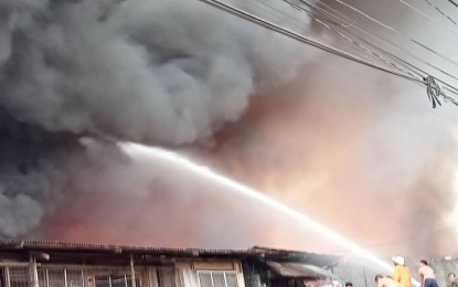 <p><strong>RAGING FIRE.</strong> Firefighters battle the blaze that has been going on since late Monday evening (June 27, 2022) in Zamboanga City. The fire hit a warehouse storing flammable coconut products, fire officials say. <em>(Photo courtesy of Cristine Falcasantos)</em></p>