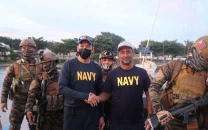 <p><strong>RESCUED AT SEA.</strong> Escorted by Navy personnel, Amir Sarkarifari (with white baseball cap), who carries a Swedish and Iranian passports, arrives at the Naval Station Romulo Espladon in Zamboanga City. Sarkarifari was rescued Saturday (June 25, 2022) while aboard a malfunctioning yacht off Sibago Island, Mohammad Ajul town, Basilan. <em>(Photo courtesy of Naval Forces Western Mindanao)</em></p>