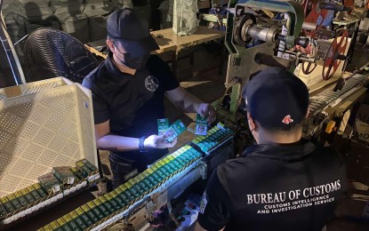 <p class="p1"><strong>BUSTED.</strong> Agents from the Customs Intelligence and Investigation Service (CIIS) inspect cigarette-making paraphernalia and other tobacco products found in a warehouse along Tanza-Trece Martires Road in Trece Martires City, Cavite on Tuesday (June 28, 2022). Authorities seized around PHP256.5 million worth of tobacco products and other cigarette-making paraphernalia during the operation.<em> (Photo courtesy of BOC)</em></p>