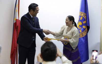 <p><strong>TURNOVER.</strong> Outgoing Presidential Communications Operations Office (PCOO) Secretary Martin Andanar turns over pertinent documents of the agency to incoming Secretary Atty. Trixie Cruz-Angeles at the Diplomatic Lounge of the Times Plaza Building in Manila in this file photo. On June 30, 2022, Cruz-Angeles said President Ferdinand R. Marcos Jr. signed Executive Order No. 2 restoring the Office of the Press Secretary to replace the PCOO. <em>(Photo courtesy of PCOO)</em></p>