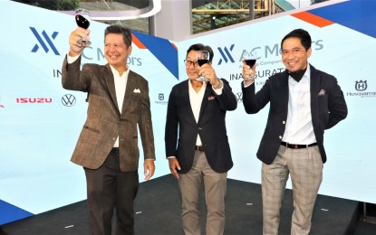 <p><strong>NEW SHOWROOM</strong>. AC Motors president Antonio Zara, AC Industrials president and chief executive officer Arthur Tan, and Adventure Cycle Philippines, Inc. president Andre Santos (from left to right)pose for a celebratory toast during the opening of AC Motors Centrale in Bonifacio Global City on June 28, 2022. AC Motors Centrale is a consolidated showroom for AC Motor brands including Honda, Isuzu, KIA, Volkswagen, Maxus, KTM, and Husqvarna.<em> (Photo courtesy of AC Motors)</em></p>