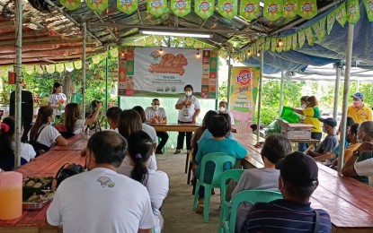 <p><strong>SHOWCASE</strong>. Agriculture Regional Executive Director Remelyn Recoter speaks before a farmers association at the Uswag Nursery in Barangay Tacas, Jaro on Wednesday. She said on Thursday (June 29, 2022) this July they expect to release the PHP5,000 Rice Farmers Financial Assistance to each of the 272, 134 recipients in the region.<em> (PNA photo by PGLena)</em></p>