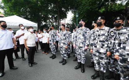 <p><strong>PSG MISSION</strong>. President Ferdinand “Bongbong” Marcos Jr. meets with Presidential Security Group (PSG) upon his arrival at the Kalayaan Grounds in Malacañang Palace for the flag raising ceremony Monday (July 4, 2022). He said the mission of the PSG goes beyond protecting the First Family.<em> (Photo courtesy of the Office of the President)</em></p>