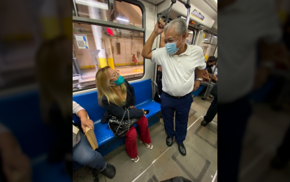 <p><strong>RIDING INCOGNITO.</strong> Transportation Secretary Jaime Bautista interacts with a passenger aboard a Metro Rail Transit Line 3 (MRT-3) train on Monday (July 4, 2022). Bautista reported his surprise inspection of the rail line during the first Cabinet meeting of President Ferdinand "Bongbong" Marcos Jr. at Malacañan Palace. <em>(Photo courtesy of DOTr)</em></p>