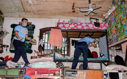 <p><strong>‘OPLAN GALUGAD’</strong>. Police personnel search through belongings of persons deprived of liberty (PDLs) at the Negros Oriental provincial jail on Wednesday (July 6, 2022). The operation comes following a directive from Governor Pryde Henry Teves to stop illegal activities inside the facility. <em>(Photo courtesy of the Negros Oriental Provincial Police Office)</em></p>