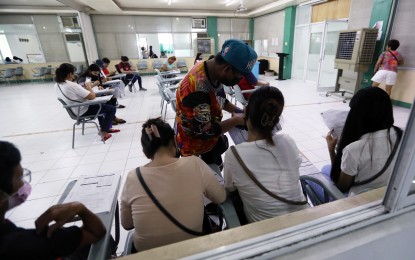 <p><strong>'REGISTER ANYWHERE'.</strong> Residents fill up voter's registration forms at the Commission on Elections (Comelec) office at the third floor of the Marikina Public Market Building along W. Paz Street in Marikina City on July 6, 2022. The poll body on Wednesday (Nov. 9, 2022) said it will pilot the Register Anywhere Project (RAP) for 10 weekends starting Dec. 17 in five malls in the National Capital Region. <em>(PNA file photo by Joey O. Razon)</em></p>