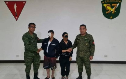 <p><strong>NPA COUPLE SURRENDERS.</strong> A couple identified as ranking members of the New People's Army (NPA) surrenders Tuesday (July 5, 2022) to the  Army’s 97th Infantry Battalion in Barangay Del Pilar in Piñan, Zamboanga del Norte. The couple is welcomed by Brig. Gen. Leonel Nicolas, the Army’s 102nd Infantry Brigade commander (left), and Lt. Col. Nolasco Coderos Jr., the 97th Infantry Battalion commander (right). <em>(Photo courtesy of 97IB)</em></p>