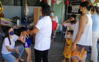 <p><strong>NUTRITION CHECK</strong>. A health worker weighs a child in Tacloban City in this June 10, 2022 photo. The activity is one of the strategies to assess the impact of the nutrition program in the communities. <em>(Photo courtesy of National Nutrition Council)</em></p>