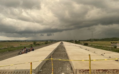 <p><strong>UNDER CONSTRUCTION</strong>. A portion of the Laoag-San Nicolas bypass road passes through vast rice fields in Barangay San Guillermo, San Nicolas, Ilocos Norte in this undated photo. Soon, an additional bypass bridge will rise near the Laoag Gilbert Bridge to solve traffic congestion in the Nangalisan area. <em>(Photo by Leilanie Adriano)</em></p>