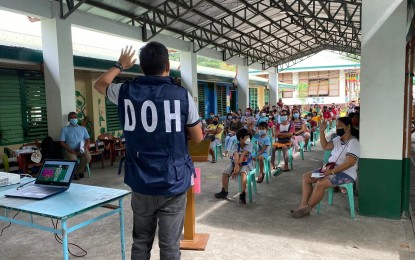 <p><strong>DOH IN ACTION</strong>. An official of the Department of Health in Bicol urges students, parents, and teachers to get vaccinated against Covid-19 during the demand generation activity in this undated photo. The DOH also encouraged the fully vaccinated individuals to get booster shots. <em>(Photo courtesy of DOH-5)</em></p>