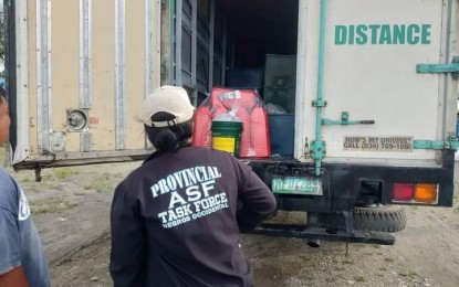 <p><strong>INSPECTION.</strong> Personnel of the Provincial African Swine Fever (ASF) Task Force in Negros Occidental check the cargo of a delivery van that arrived at a port in EB Magalona town on June 29, 2022. The provincial government continues to strengthen its border control operations to prevent the entry of live pigs and pork products and maintain the province’s ASF-free status amid the continuing threat posed by the hog disease. <em>(Photo courtesy of Negros Occidental Provincial Veterinary Office) </em></p>