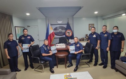 <p><strong>VTMS MANUAL.</strong> Philippine Coast Guard (PCG) Commandant Admiral Artemio Abu (3rd from left) and other officers of the PCG join the signing of the Center Cebu operations manual on the Vessel Traffic Management System (VTMS) at the PCG headquarters in Port Area, Manila on Wednesday (July 6, 2022). The PCG said the manual would serve as a guide and provide standard approaches on VTMS for safe and efficient navigation in the Cebu-Mactan channel. <em>(Photo courtesy of PCG)</em></p>