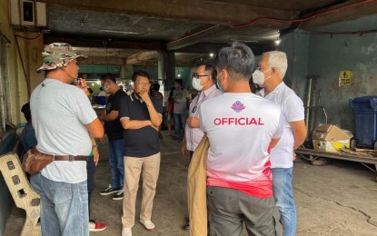 <p><strong>MARKET VISIT</strong>. Mayor Domingo Ambrocio Jr. (in black polo shirt) visits the San Nicolas public market on July 7, 2022. The new mayor said he will prioritize improvements in the public markets. <em>(Contributed photo)</em></p>