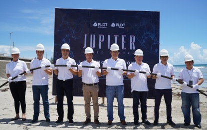 <p><strong>JUPITER CABLE</strong>. Local and provincial government officials from Daet, Camarines Norte pose with executives of PLDT-Smart during the inauguration of the Jupiter Cable System landing station in the town on July 12, 2022. The cable system has been fired up since Friday (July 29, 2022) and is seen to boost the country's international data capacity and image as an investment destination.<em> (Photo courtesy of PLDT)</em></p>