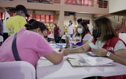 <p><strong>PAYOUT</strong>. Beneficiaries of the Department of Social Welfare and Development cash-for-work scheme receive their compensation during payout at the Don Honorio Ventura State University in Bacolor, Pampanga on Monday (July 11, 2022). A total of 1,060 beneficiaries from the municipalities of Arayat, Mexico, Santo Tomas, and the City of San Fernando were given P4,200 each for their 10 days of work. <em>(Photo courtesy of Pampanga PSWDO)</em></p>