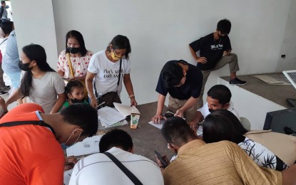 <p><strong>REGISTRATION</strong>. Voters fill up registration forms outside the Commission on Elections (Comelec) office in Tacloban City in this July 4, 2022 photo. During the first week of registration, the Comelec has listed 12,694 new registrants in Eastern Visayas in this year’s Barangay (village) and Sangguniang Kabataan (youth council) elections. <em>(Photo courtesy of Comelec)</em></p>