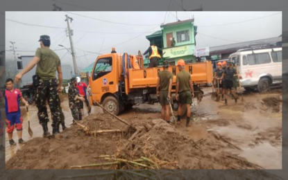 <p><strong>CLEARING OPS.</strong> Army troops and reservists, along with other volunteers, clear a major road affected by a mudslide in Banaue, Ifugao on Tuesday (July 12, 2022). Heavy monsoon rains triggered flash floods and landslides in the town, affecting 10 villages and about 1,054 families, based on data from the National Disaster Risk Reduction and Management Council. <em>(Photo courtesy of Philippine Army)</em></p>