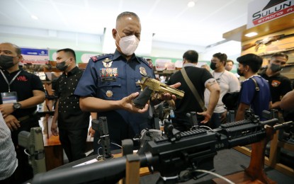 <p><strong>ARMS SHOW.</strong> Philippine National Police (PNP) officer in charge (OIC) Lt. Gen. Vicente Danao looks at the firearms on display at the Association of Firearms and Ammunitions Dealers of the Philippines Inc (AFAD) Defense and Sporting Arms Show at a mall in Mandaluyong City on Thursday (July 14, 2022). Some 48 members and exhibitors are participating in the gun show that will run until July 18. <em>(PNA photo by Joey O. Razon)</em></p>