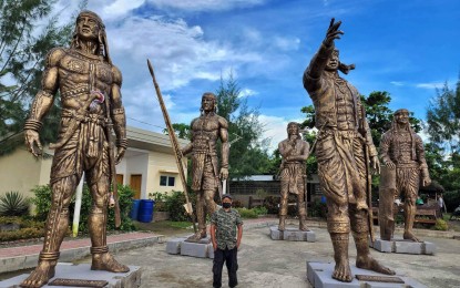 <p><strong>AMONG THE GIANTS</strong>. Artist John Alaban stands amid his ultra-size statues of Bornean datus or chieftains in this photo taken July 13, 2022. Juan Carlos Perlas, Antique Provincial Tourism and Cultural Affairs supervising administrative officer, said on Thursday (July 14) the sculptures will be installed at the Malandog Esplanade in Hamtic town.<em> (Photo courtesy of Antique Provincial Tourism and Cultural Affairs Office)</em></p>