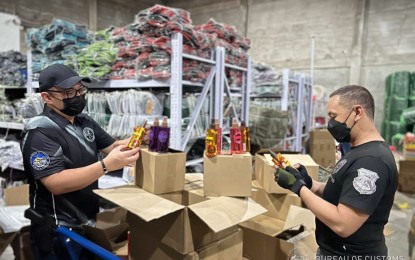 <p class="p1"><strong>SEIZED.</strong> Customs agents conduct an inspection of a warehouse in Valenzuela City on Wednesday (July 13, 2022). Authorities seized some PHP1.5 billion worth of smuggled goods and fake luxury items during the inspection. <em>(Photo from BOC)</em></p>