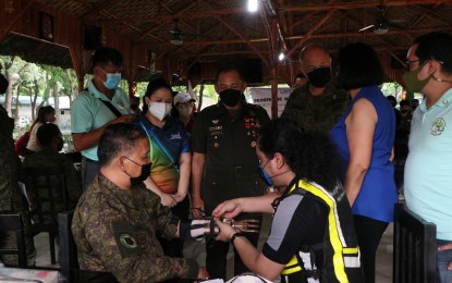 <p><strong>AIDING AMPUTEES.</strong> A donor fits a prosthetic hand to an amputee soldier at the Civil-Military Operations Regiment headquarters in Fort Bonifacio, Metro Manila on July 13, 2022. The GMA Kapuso Foundation and LN4 Hand Foundation, an international donor of prosthetic hands, turned over the prostheses to more than 50 recipients consisting of amputee soldiers, Cafgu Active Auxiliary, military dependents, and civilians. <em>(Photo courtesy of the Philippine Army)</em></p>
