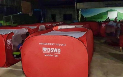 <p><strong>TENTS FOR EVACUEES.</strong> The Department of Social Welfare and Development in Soccsksargen installs 15 modular tents as temporary shelters for flood victims in Barangay Lampitak, Tampakan, South Cotabato. One died while 200 families evacuated to safer grounds after flooding spawned by heavy rains inundated several barangays of the town on Saturday (July 16, 2022). <em>(Photo courtesy of DSWD-12)</em></p>