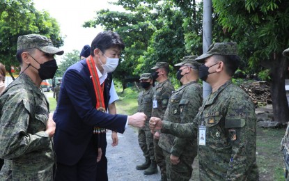 <p><strong>MORE AID.</strong> Japan's Parliamentary Vice Minister of Defense Tsuyohito Iwamoto (center) greets troops of the Philippine Army's 525th Engineer Combat "Mandirigtas” Battalion troops in Fort Bonifacio on Monday (July 18, 2022). Iwamoto reaffirmed the Japanese government’s commitment to helping beef up the PA's disaster response capabilities. <em>(Photo courtesy of Philippine Army)</em></p>
