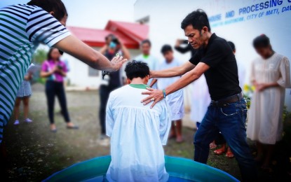 <p><strong>BAPTISM.</strong> Ten former members of the communist New People's Army (NPA) in Davao Oriental decide to restore their Christian faith through baptism on July 18, 2022. On the same day, they also graduated from the government's Enhanced Comprehensive Local Integration Program.<em> (Photo courtesy of Davao Oriental PIO)</em></p>