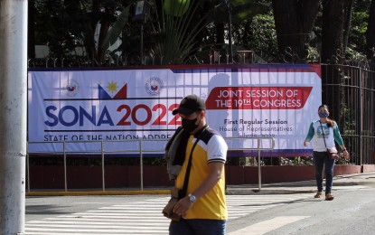 <div class="caption">
<p><strong>FIRST SONA.</strong> Pedestrians walk past a tarpaulin announcing the first State of the Nation Address of President Ferdinand "Bongbong" Marcos Jr. at the Batasang Pambansa Complex in Batasan Hills, Quezon City on Friday (July 22, 2022).  Marcos will bare his policies and plans for the nation on Monday afternoon (July 25). <em>(PNA photo by Joey O. Razon)</em></p>
</div>