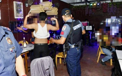 <p><strong>INSPECTION</strong>. The Cagayan de Oro Regulatory Compliance Board joins the city police office in the conduct of "Oplan Rekisa" inside a bar on Friday evening (July 23, 2022). The local government reminded the public that drinking alcoholic beverages, liquor, and other intoxicating drinks in public places is prohibited under a city ordinance. <em>(Photo courtesy of Reynan Baylin)</em></p>