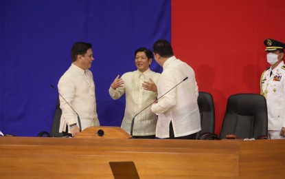 <p>PRIORITY BILLS. President Ferdinand “Bongbong” Marcos Jr. shares light moments with House Speaker Martin Romualdez (right) and Senate President Juan Miguel Zubiri (left) during the chief executive’s 1st State of the Nation Address at the Batasang Pambansa in Quezon City on July 25, 2022. Romualdez said the House would fast-track the approval of eight of the 19 priority bills mentioned by Marcos in his SONA.<em> (PNA photo)</em></p>