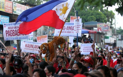 <p><strong>SHOW OF FORCE.</strong> Supporters of President Ferdinand “Bongbong” Marcos Jr. gather along IBP Road in Quezon City as the Chief Executive delivers his first State of the Nation Address (SONA) at the Batasang Pambansa on Monday (July 25, 2022). Organizers estimated that around 20,000 people from different parts of Metro Manila and nearby provinces joined the event to support Marcos' maiden SONA. <em>(PNA photo by Joey O. Razon)</em></p>