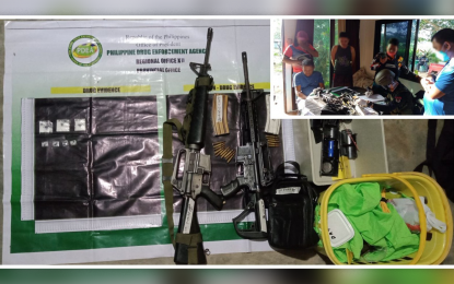 <p><strong>FATHER-SON TANDEM.</strong> A police officer accounts for the firearms and illegal drugs seized Monday (July 25, 2022) from a father-son tandem (in handcuffs, inset) suspected of involvement in drugs and illegal firearms in M’lang, North Cotabato. Authorities said the two are members of the Moro Islamic Liberation Front in the area based on identification cards seized from them. <em>(Photo courtesy of PDEA-Soccsksargen)</em></p>