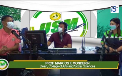 <p>Professor Marcos Monderin (extreme left), dean of the College of Arts and Sciences of the University of Southern Mindanao (USM) based in Kabacan, North Cotabato, speaks during a radio program Tuesday (July 26, 2022). <em>(Screengrab from KOOL FM–North Cotabato)</em></p>