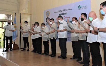<p><strong>OATH-TAKING</strong>. Officers of the Negros Association of Local Chief Executives (ACE) led by its president, Mayor Javier Miguel Benitez of Victorias City (2nd from left), take oath before Governor Eugenio Jose Lacson (left) in a ceremony held at the Social Hall of the Provincial Capitol in Bacolod City on Wednesday (July 27, 2022). The Negros ACE has unanimously approved a resolution supporting the bills filed in the House of Representatives for the creation of the expanded Negros Island Region. <em>(Photo courtesy of PIO Negros Occidental)</em></p>