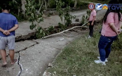 <p><strong>CRACKED.</strong> Personnel of the City Engineering Office assess the roads in San Fernando City, La Union following the magnitude 7 earthquake on July 27, 2022. The Department of Public Works and Highways has already recorded PHP125 million in damage to roads and bridges in the region. <em>(Photo courtesy of City of San Fernando La Union)</em></p>