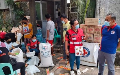 <p><strong>RELIEF AID</strong>. Volunteers of the Philippine Red Cross help pack rice for distribution to affected families in Abra province on Thursday (July 28, 2022). The National Food Authority has assured the public it has enough rice supply for release. <em>(Photo courtesy of NFA Ilocos Norte branch)</em></p>
